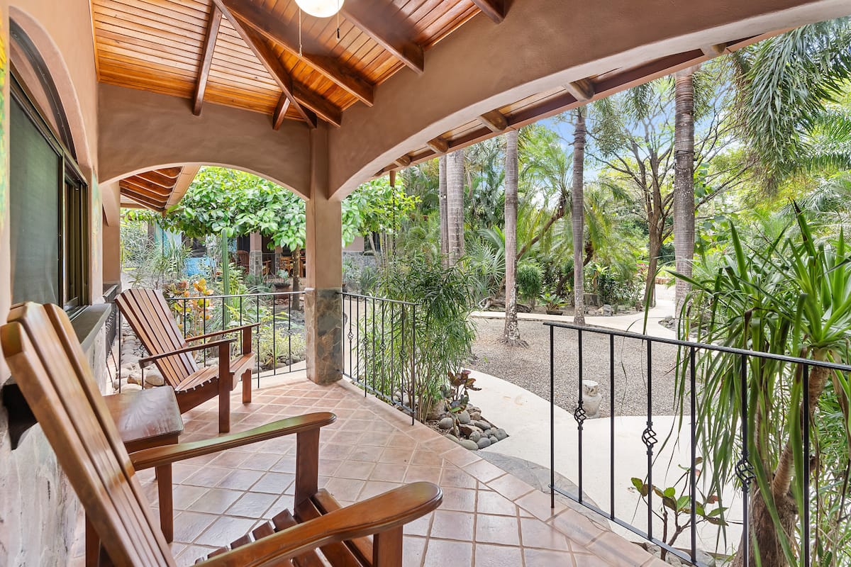 Covered terrace with rocking chairs outside a cabina